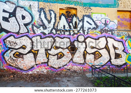 Saint-Petersburg, Russia - May 6, 2015: Abandoned urban courtyard with colorful abstract graffiti text patterns on old brick wall. Vasilievsky island, St. Petersburg