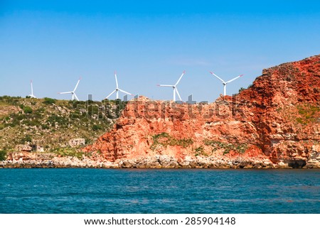 Kaliakra headland. Bulgaria, Black Sea. Coastal landscape with red cliff and wind turbines