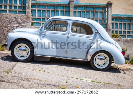 Ajaccio, France - July 6, 2015: Light blue Renault 4CV old-timer economy car stands parked on a roadside in French town, side view