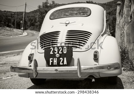 Ajaccio, France - July 6, 2015: White Renault 4CV old-timer economy car stands parked on a roadside in French town, close-up rear view