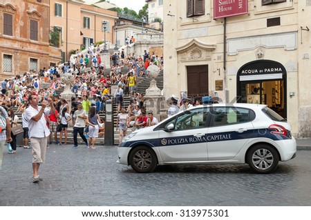 Rome, Italy - August 07, 2015: White Police car stands on the street near Spanish stairs in historical center of Rome city