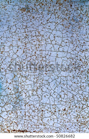Old metal wall texture with abstract pattern on cracked blue painting