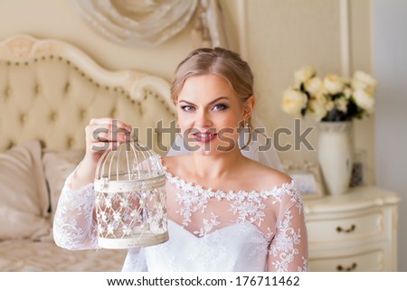 bride holding vintage bird cage in hand