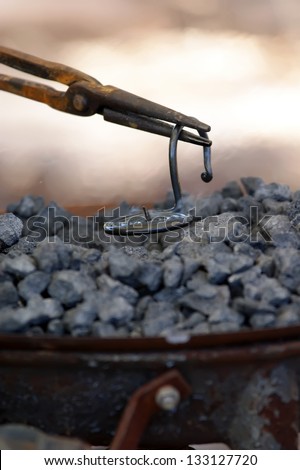 iron smith working near hot coal
