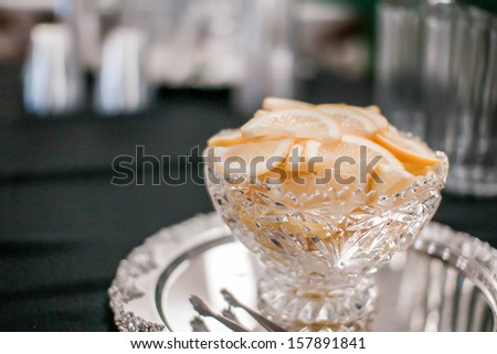sliced lemon in a glass dish at party table