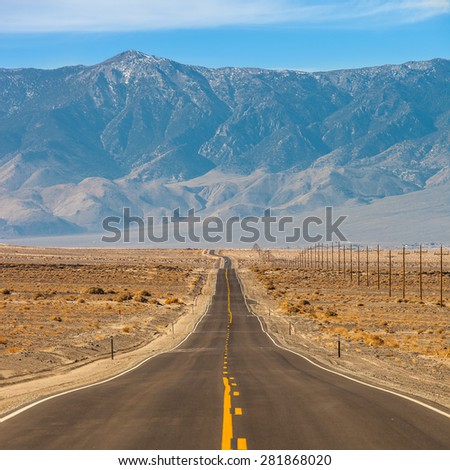 Long straight highway in the foothills of Sierra Nevada mountains
