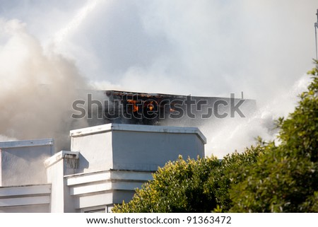 SAN FRANCISCO, CA - DECEMBER 22: Firefighters pouring water on a burning building on the corner of Golden Gate Ave and Pierce St in Western Addition district December 22, 2011 in San Francisco CA