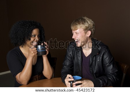 Friends laughing over a cup of coffee