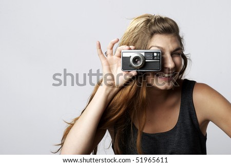 Beautiful Girl taking picture with vintage camera