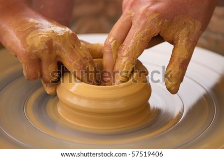 Closeup on hands of potter on potter\'s wheel