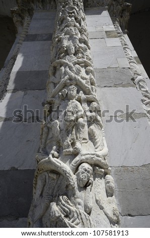 LUCCA, ITALY - JUNE 11: column with relief shown different religious symbols on Duoma San Martino the cathedral of Lucca on June 11, 2012 in Lucca, Italy