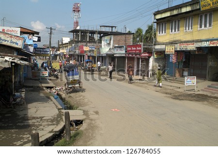 ASSAM, INDIA - SEPTEMBER 30: Unidentified people in a dusty and poorly shopping street in an unknown village on the main road between Bhutan and Gauharti city on September 30, 2007, in Assam, India