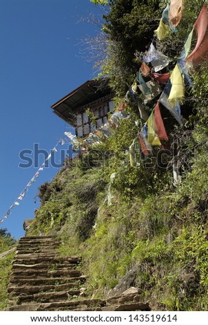 Bhutan, prayer flags and steps to a home for meditation of the monks of Taktsang monastery