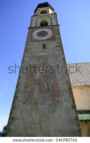 Italy, South Tirol, medieval church of St. Constantine with painting on the church spire, first mentioned in 13th century