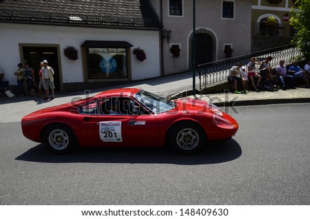 LUNZ, AUSTRIA - JULY 19: Unidentified spectators and Ferrari Dino on special stage by International Ennstal Classic 2013, a yearly tournament for vintage cars on July 19, 2013, in Lunz am See, Austria
