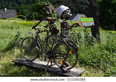 DUERNSTEIN, AUSTRIA - JUNE 30: Funny sculpture with bicycle and old tools as sign to a tavern in the Unesco World Heritage site in Danube valley on June 30, 2013 in Duernstein, Austria