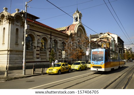 SOFIA, BULGARIA - SEPTEMBER 28: Unidentified people, public tram and cars on Knyaginya Maria Louise Boulevard, left the Central Sofia Market building, on September 28, 2013 in Sofia, Bulgaria