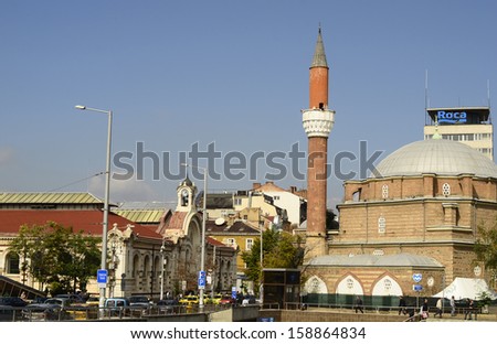 SOFIA, BULGARIA - SEPTEMBER 28: Unidentified people and traffic between central Sofia market hall,  a covered market in the centre - and Banya Bashi mosque with minaret, on September 28, 2013 in Sofia