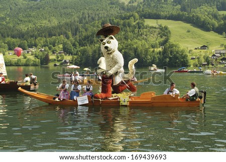 BAD AUSSEE, AUSTRIA - MAY 30: Unidentified people on boat on Grundlsee by Daffodil Festival aka Narzissenfest, a yearly event in Salzkammergut, Styria, on May 30, 2005 in Bad Aussee, Austria
