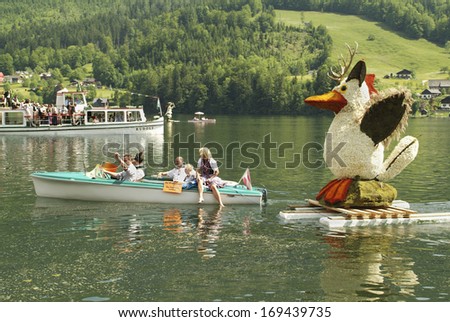 BAD AUSSEE, AUSTRIA - MAY 30: Unidentified people on boat on Grundlsee by Daffodil Festival aka Narzissenfest, a yearly event in Salzkammergut, Styria, on May 30, 2005 in Bad Aussee, Austria