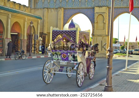 MEKNES, MOROCCO - NOVEMBER 19: Unidentified people and wedding horse drawn coaches at gate Bab Moulay Ismail, on November 19, 2014 in Meknes, Morocco