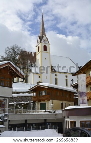 FIEBERBRUNN, AUSTRIA - MARCH 06: Catholic church and homes in the village and preferred ski resort in Tirol in winter landscape, on March 06, 2015 in Fieberbrunn, Austria