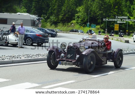 FERNSTEIN, AUSTRIA - JUNE 27: Unidentified people in vintage car Alfa Romeo by classical rallye on Fernpass mountain road in Tirol, on June 27, 2014 in Fernstein, Austria
