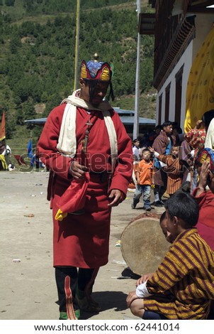 HAA, BHUTAN - SEPTEMBER 21: unknown spectators and musician by religious festival named Tshechu in Haa, Western Bhutan, in the White Temple on September 21, 2007 in Haa Village in Bhutan
