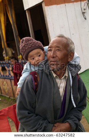 HAA, BHUTAN - SEPTEMBER 21: unknown spectators at the religious festival named Tshechu in the White Temple (Karpho Lhakhang) on September 21, 2007 in Haa, Bhutan