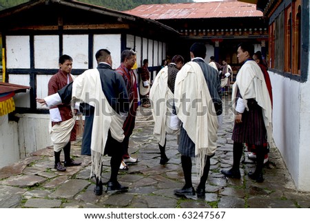 HAA, BHUTAN - SEPTEMBER 21: unknown spectators in the traditinal Gho with  at the religous festival named Tshechu in the White Temple (Karpho Lhakhang) on September 21, 2007 in Haa, Bhutan