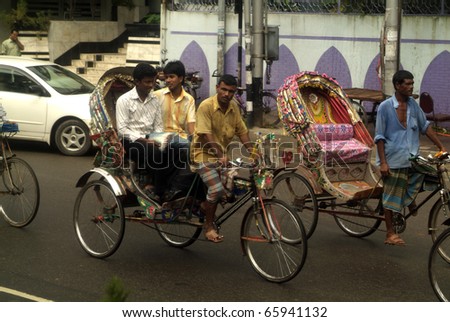 DHAKA, BANGLADESH - SEPTEMBER 17: Unidentified Bengali people and rickshaw driver endure the rush hour on September 17, 2007 in Dhaka, Bangladesh