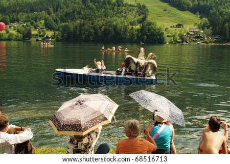 BAD AUSSEE, AUSTRIA - MAY 30: Unidentified people with flower-decorated sculpture on boat by Festival of Narcissus on the Grundlsee(Lake) on May 30, 2005 in Bad Aussee in Styria, Austria
