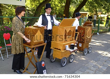 VIENNA, AUSTRIA - SEPTEMBER 02: unidentified musicians with their barrel organs in the yearly meeting for organ grinders in the Bohemian Prater on September 02, 2006 in Vienna