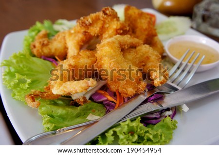 Japanese Cuisine. Fried organic coconut Shrimp with cocktail sauce and fresh lettuce on a plate