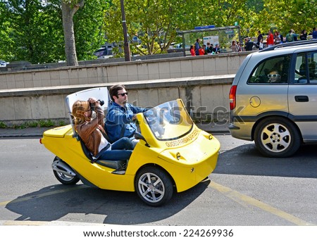 PARIS - August 22: Tourists on a rented car photograph attractions on August 22,2014 in Paris, France. Cars with navigation system and audio guide, have already attracted many tourists