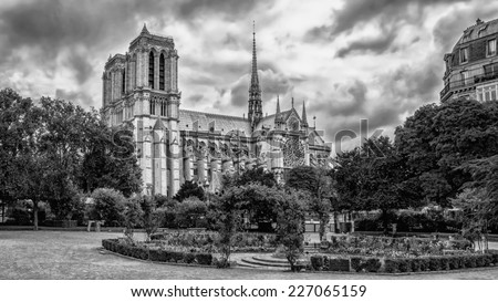 View of the Cathedral of Notre Dame de Paris from old city park before the storm. Paris, France.
