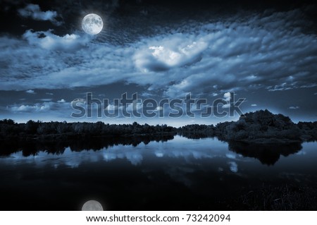 Beautiful full moon reflecting in a lake