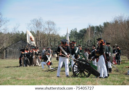 IGANIE, POLAND - APRIL 16: Members of Historic Artillery Group load a cannon at Battle of Iganie (1831) reenacted on a battlefield on 180th anniversary on April 16, 2011 in Iganie, Poland