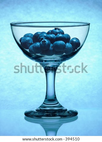A dramatic display of blueberries in a fruit cup.
