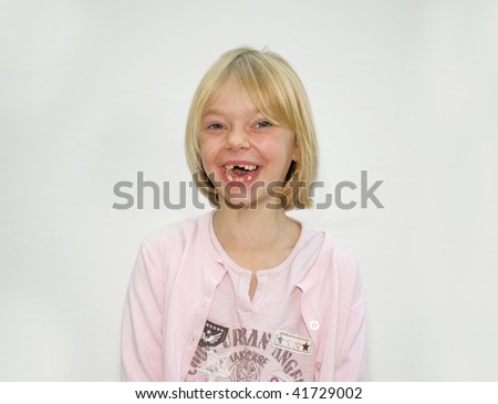 Young Girl Laughing with no Teeth