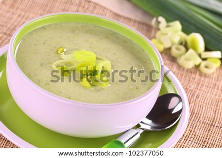 Bowl full of fresh homemade creamy leek soup (Selective Focus, Focus on the leek rings on the top of the soup)