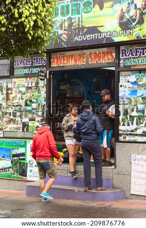 BANOS, ECUADOR - FEBRUARY 25, 2014: Unidentified people at Geotours travel agency and tour operator on Ambato Street on February 25, 2014 in Banos, Ecuador. Banos offers many outdoor activities.