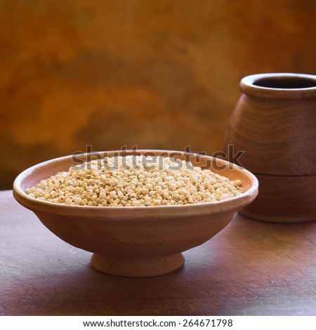 Popped white quinoa (lat. Chenopodium quinoa) cereal in bowl photographed with natural light (Selective Focus, Focus one third into the quinoa cereal)