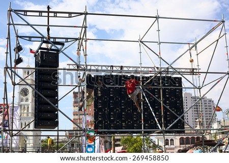 IQUIQUE, CHILE- JANUARY 22, 2015: Unidentified men working on big screen set up for the event called Tunas y Estudiantinas held at the end of January in the city, on January 22, 2015 in Iquique, Chile