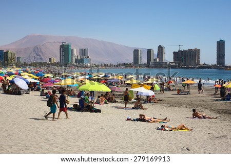 IQUIQUE, CHILE - JANUARY 23, 2015: Unidentified people enjoying the summer on the crowded Cavancha beach on January 23, 2015 in Iquique, Chile. Iquique is a popular beach town in Northern Chile.