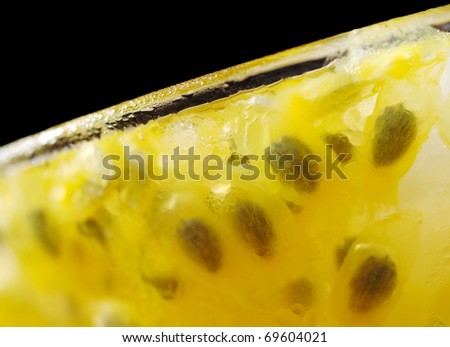 Closeup of cold passion-fruit juice in glass (Very Shallow Depth of Field, Focus on part of the rim and part of the front of the glass)