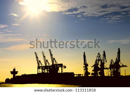 Silhouette of portal cranes in harbor
