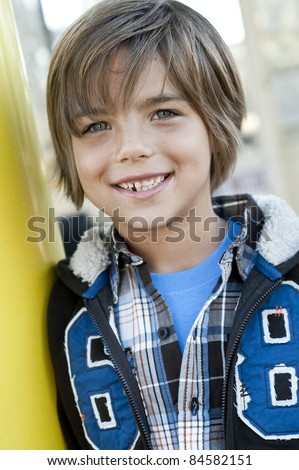 outdoor portrait of cute 7 yr old boy, jacket with hood, number 68