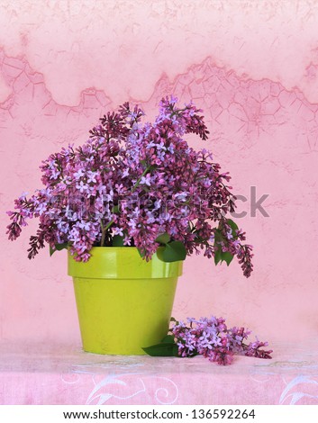 Lilac flower arrangement on a vintage background.