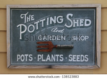 Old weathered sign of a potting shed.